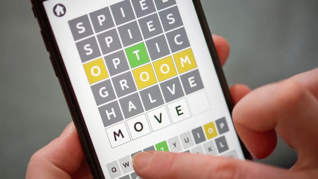 alt="Close-up of NYT Wordle grid showing guesses with green, yellow, and gray tiles"