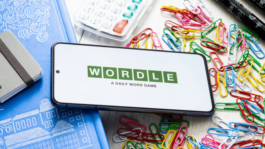 alt="NYT Wordle game on a smartphone with colorful letter tiles"