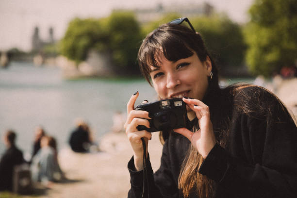 "Photographer using Photeeq lens flare effect for creative photo editing outdoors"